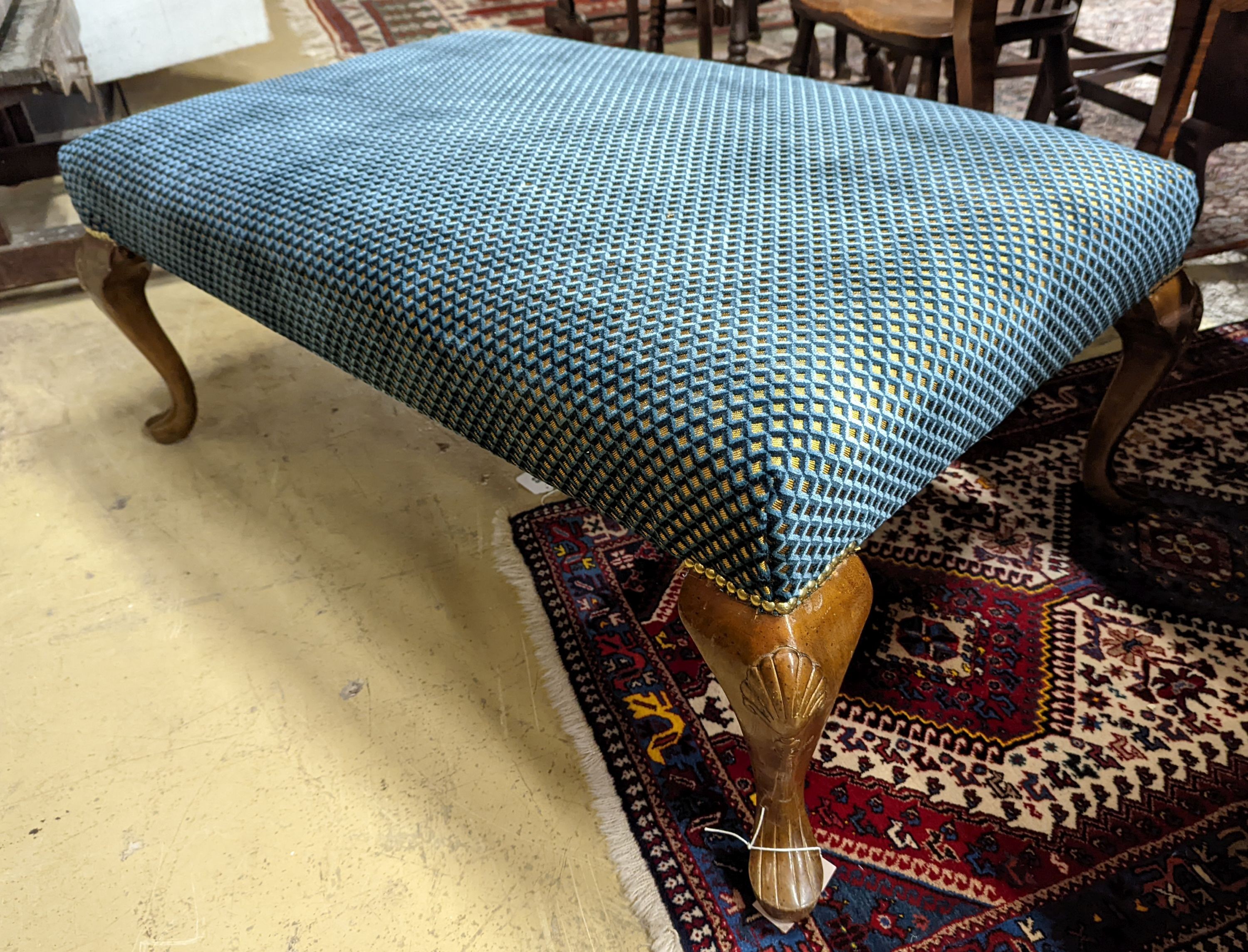 An upholstered footstool. W-117cm, D-73cm, H-44cm.